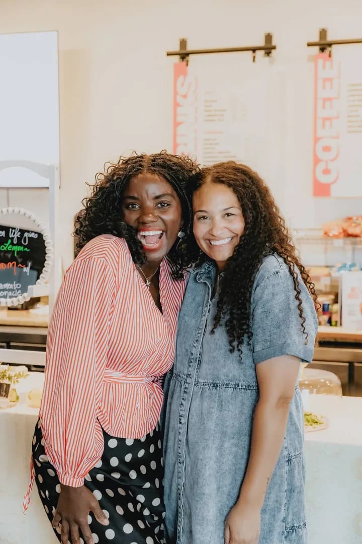 Two women smiling together at a Sacramento Tabernacle gathering