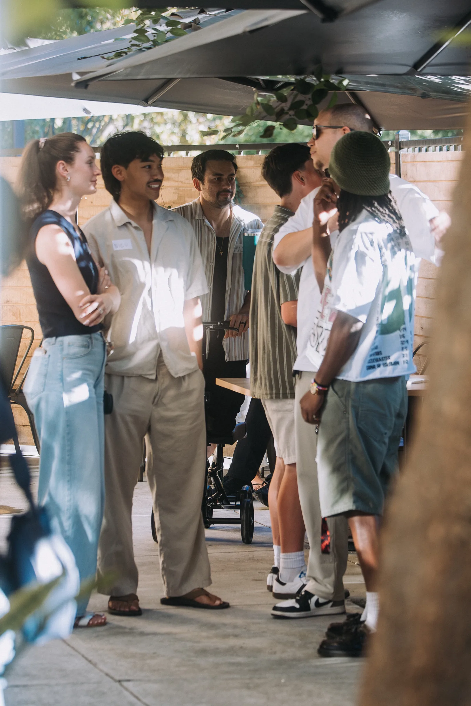 A group smiling and talking outdoors at a Sacramento Tabernacle community gathering
